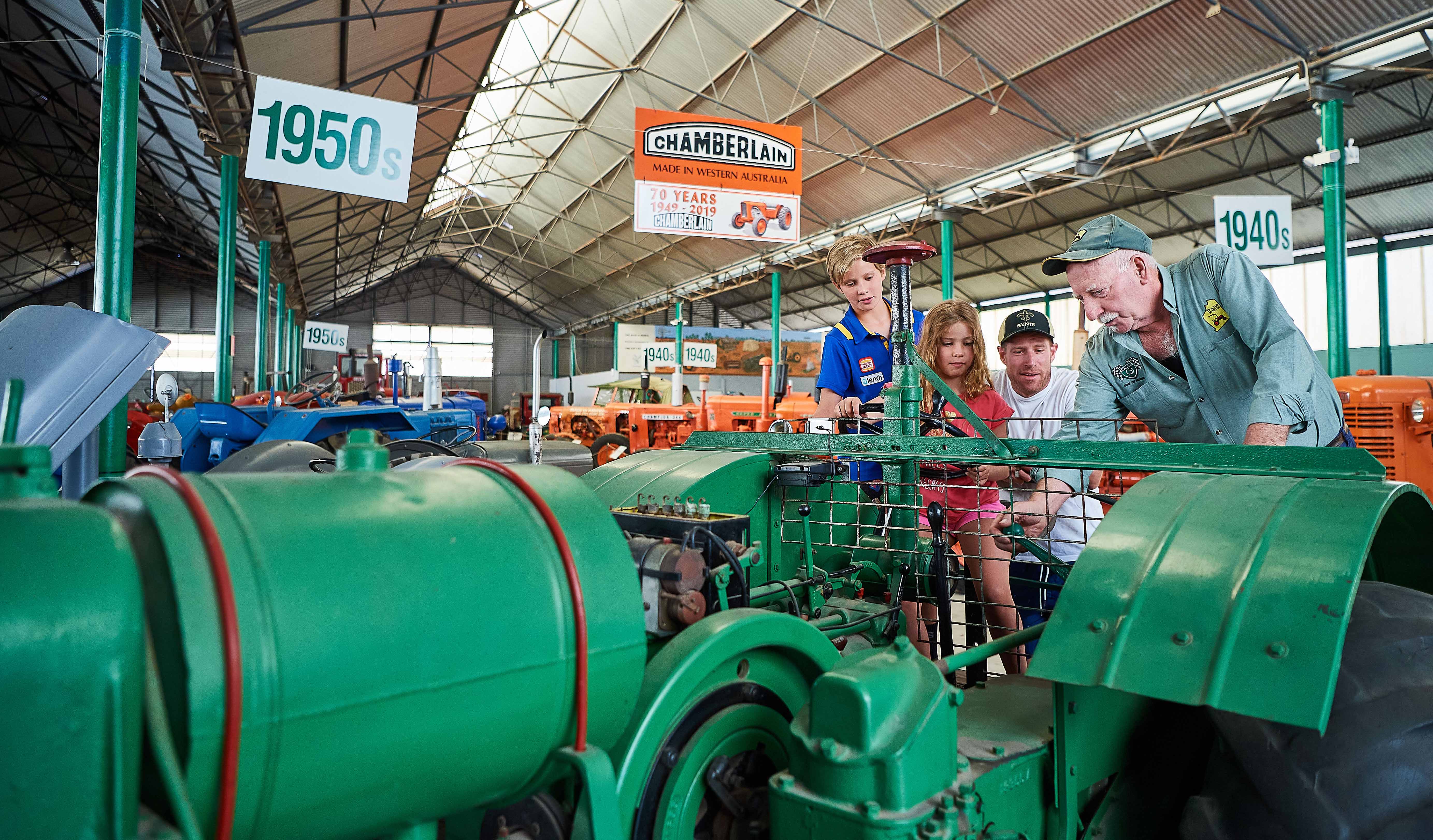 Whiteman Park Volunteer explaining family Tractor Museum of WA 1MB